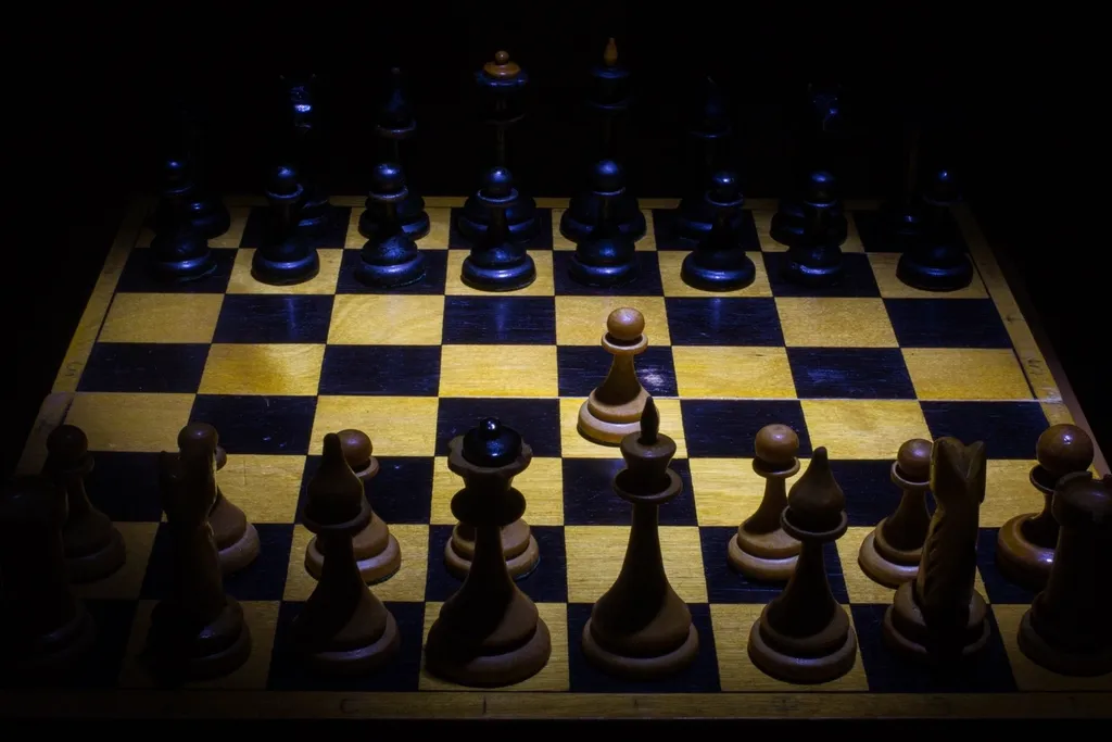 Chessboard with black pieces on a dark background