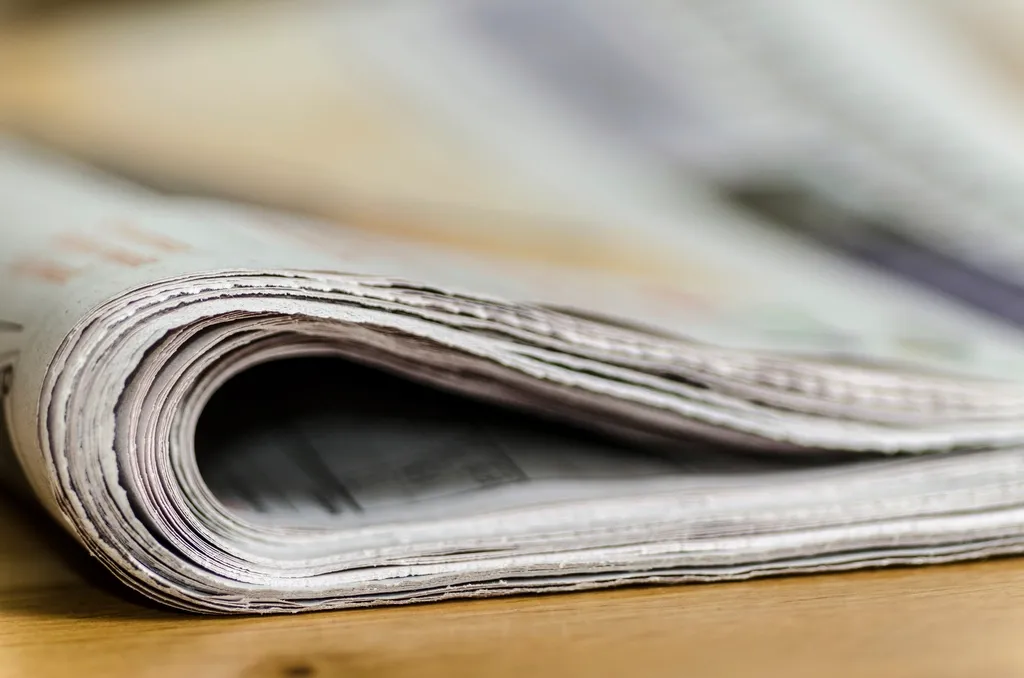 Folded newspaper seen up close, page edges visible