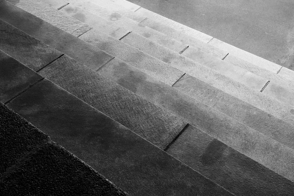 Grey stone steps seen from above, from light into shadow